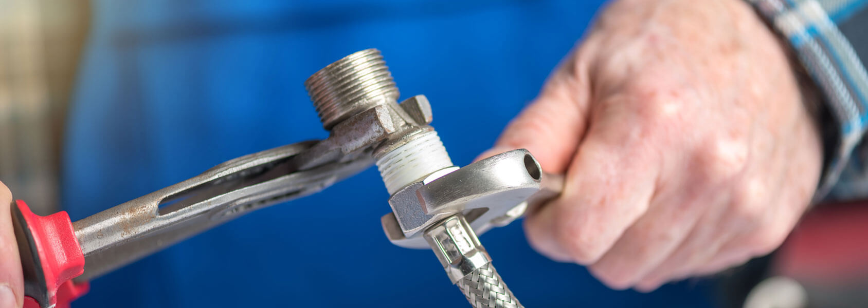 Plumber Screwing A Plumbing Fitting