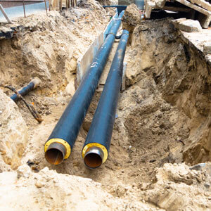Water Pipes In Ground Pit Trench Ditch During Plumbing Under Construction Repairing.